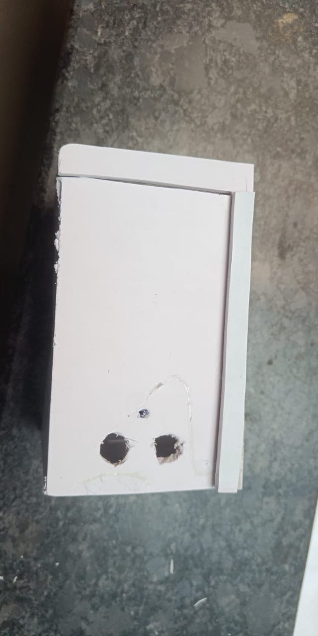 Front panel of the foam-board enclosure with openings for the sensors and camera