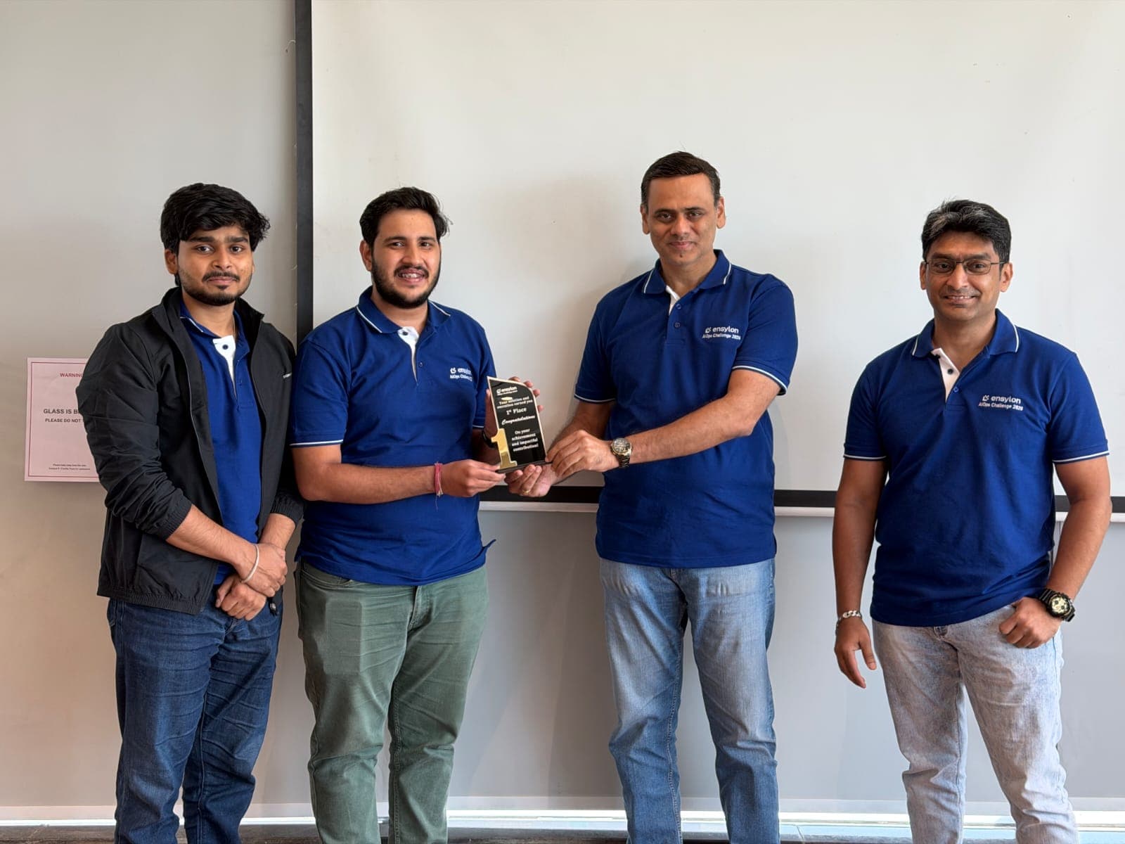 Team CommIQ receiving the 1st place trophy at the Ensylon AIOps Challenge 2026